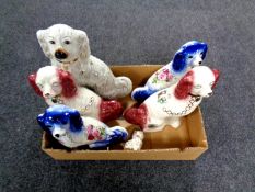 A box containing two pairs of Staffordshire spaniels together with two further Staffordshire