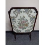 An antique mahogany and tapestry fire screen/table