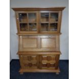 A contemporary hardwood secretaire bookcase fitted cupboards beneath