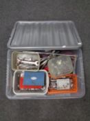 A plastic storage crate containing a large quantity of socket sets and spanners