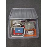 A plastic storage crate containing a large quantity of socket sets and spanners