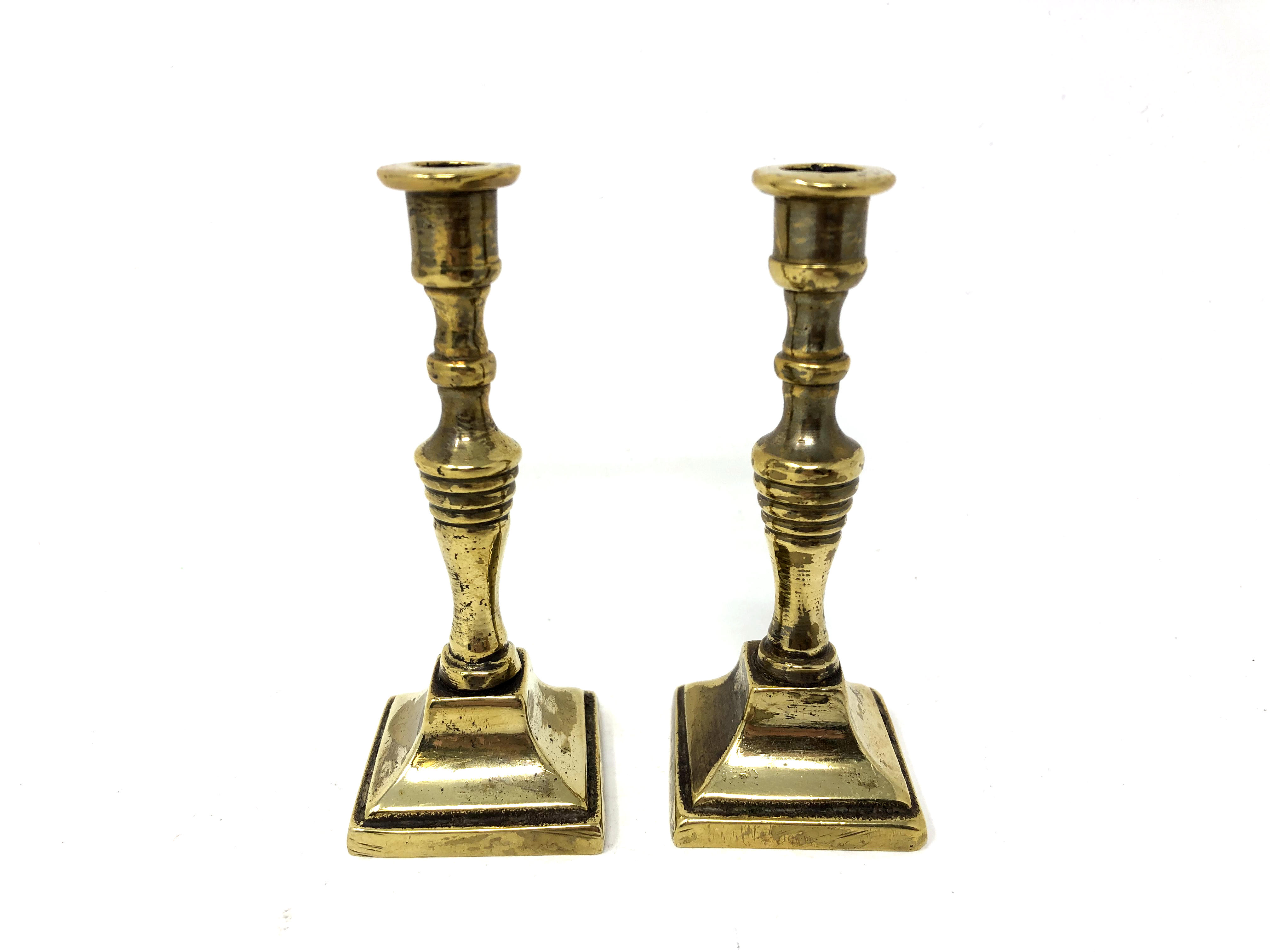 A pair of antique miniature brass candlesticks , height 8.5 cm.