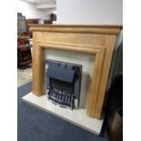 A chrome framed coal effect electric fire with cream marble hearth and back,