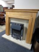 A chrome framed coal effect electric fire with cream marble hearth and back,