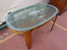 A 20th century walnut coffee table with glass panel top