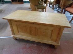 A blonde oak blanket chest