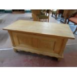 A blonde oak blanket chest