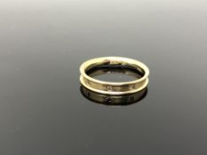 A 9ct gold diamond set band ring, size O.