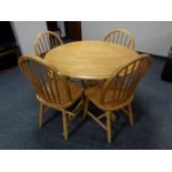 A plantation rubber wood circular pedestal dining table together with four chairs