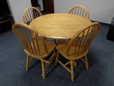 A plantation rubber wood circular pedestal dining table together with four chairs