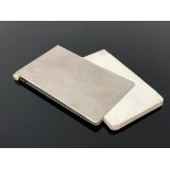 A vintage notebook with silver plated cover and pencil
