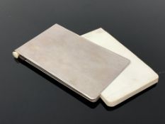 A vintage notebook with silver plated cover and pencil