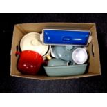 A box containing cast iron and ceramic oven dishes to include Le Creuset and Denby