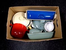 A box containing cast iron and ceramic oven dishes to include Le Creuset and Denby