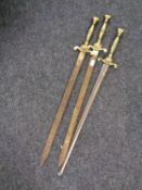 Three brass handled ornamental swords