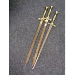 Three brass handled ornamental swords