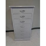 A painted pine narrow seven drawer chest