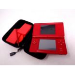 A Nintendo DS with stylus in carry case,