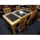 A contemporary pine dining table with three travertine tile inset panels together with a set of
