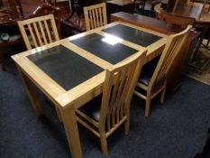 A contemporary pine dining table with three travertine tile inset panels together with a set of