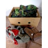 A box containing military clothing, leather holsters, belts,