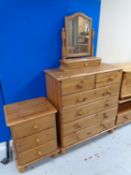 A pine six drawer chest with dressing table mirror together with matching three drawer bedside
