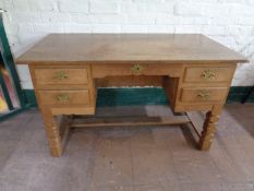 A continental oak twin pedestal desk fitted five drawers