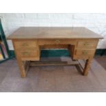 A continental oak twin pedestal desk fitted five drawers