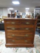 A late 19th century walnut five drawer chest with brass drop handles