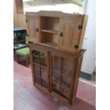 A pine double door wall cabinet fitted central shelves together with an antique mahogany bookcase