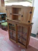 A pine double door wall cabinet fitted central shelves together with an antique mahogany bookcase