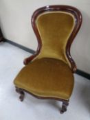 A Victorian mahogany framed lady's chair upholstered in a gold dralon