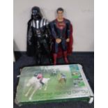 A boxed horse racing derby game together with two large action figures,