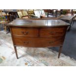 An Edwardian mahogany bow fronted three drawer chest with glass top