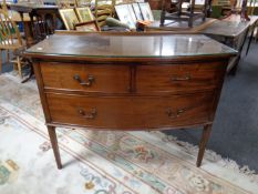 An Edwardian mahogany bow fronted three drawer chest with glass top