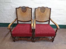 A pair of early 20th century beech framed bergere backed armchairs