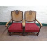 A pair of early 20th century beech framed bergere backed armchairs