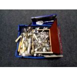 A basket of a large quantity of boxed and unboxed stainless steel and plated cutlery