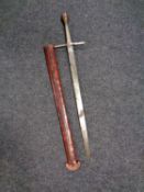 A short sword in leather scabbard