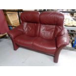 A Burgundy leather two seater reclining settee
