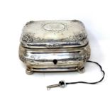 A 19th century German silver tea caddy, coat of arms to lid, on ball feet, original silver key.