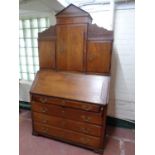 A 19th century continental oak bureau bookcase fitted cupboards above,