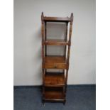A Regency simulated rosewood five tier whatnot stand fitted a drawer
