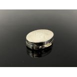 A chrome plated pill box