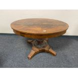 A nineteenth century Continental mahogany oval dining table on pedestal base