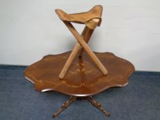 A shaped Italianate pedestal coffee table together with a tooled leather folding stool