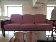 A 20th century continental wood framed settee with pink cushions
