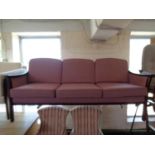 A 20th century continental wood framed settee with pink cushions