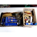 A box and two baskets containing a quantity of Hornby Dublo track, control boxes, buildings,