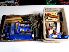 A box and two baskets containing a quantity of Hornby Dublo track, control boxes, buildings,